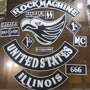 Może przedstawiać: Kolekcja czarno-białych haftowanych naszywek z różnymi wzorami i tekstami. Naszywki zawierają słowa "ROCK MACHINE", "UNITED STATES" i "ILLINOIS". Inne naszywki przedstawiają orła, liczbę "666" i litery "MC".