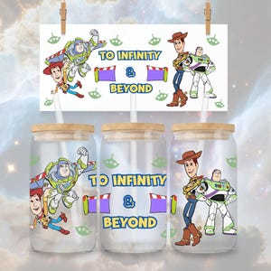 May include: Three clear glass tumblers with wooden lids and straws, featuring Toy Story characters Buzz Lightyear and Woody. The phrase "TO INFINITY & BEYOND" is printed on the tumblers and a card above. Green alien graphics are also present.
