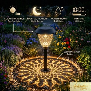 May include: A solar-powered garden light with a black post and a diamond-patterned glass shade. The light projects a warm, decorative pattern onto the ground. Features include solar charging, night activation, and a 10-hour runtime. The text on the image says "Amberglow Lighting".