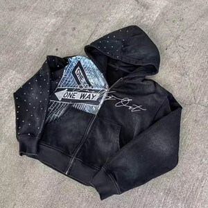 May include: Black zip-up hoodie with a distressed look. Features a "ONE WAY" graphic on the front, a dotted pattern on the left sleeve, and white script on the right side. The hood is also black.