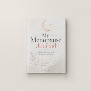 May include: A white journal titled My Menopause Journal: A Daily Symptom & Wellness Tracker. The cover features a crescent moon, small stars, and a delicate leaf illustration in soft peach and grey tones, with the brand name OLEXIOR at the bottom.