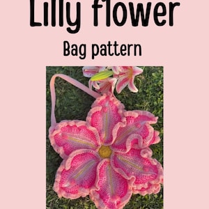 May include: A pink crocheted bag in the shape of a lily flower, with a handle. The bag is on a background of green grass. Text on the image reads "Beginners friendly", "Lilly flower", "Bag pattern", and "Crocheby Zaina".
