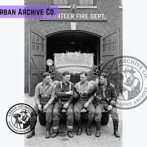 May include: A black and white photograph showing four firefighters sitting on the front bumper of a vintage fire truck in front of a brick fire station labeled VOLUNTEER FIRE DEPT. The firefighters wear work shirts, suspenders, and boots.