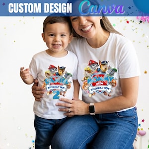 May include: White t-shirts with a colorful graphic of cartoon dogs, the text "BIRTHDAY BOY" and "MOM of the BIRTHDAY BOY". The child's shirt has the number "2". The top banner reads "CUSTOM DESIGN Canva".