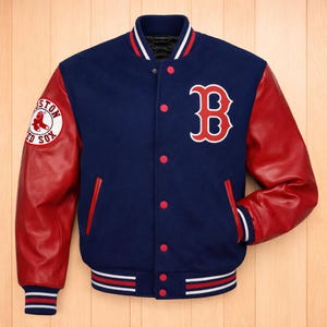 May include: A navy blue varsity jacket with red leather sleeves. The jacket features the Boston Red Sox logo on the left sleeve and a large "B" on the chest. The jacket has red and white striped trim on the collar, cuffs, and hem.