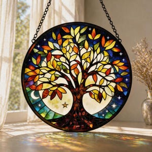 May include: A circular stained glass window depicting a tree of life. The tree has a brown trunk and branches with colourful leaves in yellow, orange, and red. The background is a night sky with stars and a crescent moon.