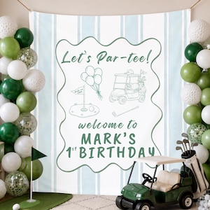 May include: A golf-themed birthday backdrop featuring light blue vertical stripes and a central white panel with green text reading Let's Par-tee! welcome to MARK'S 1st BIRTHDAY, surrounded by line art of balloons, a golf cart, and a flag.