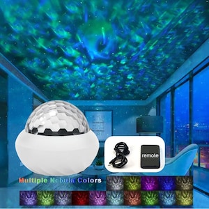 May include: A white nebula projector with a faceted globe design, projecting blue and green nebula patterns onto a ceiling. Includes a remote and USB cable. The image shows multiple nebula color options.