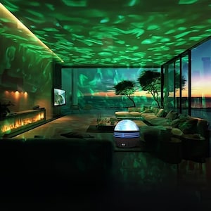 May include: A modern living room illuminated by a green wave-like light projection on the ceiling and walls. A spherical light projector sits on the floor, casting the effect. The room features a large window with a view of trees and a sunset.