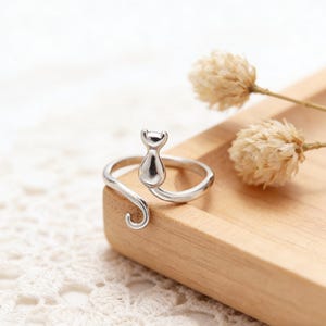 May include: A rustic wooden sign with the text "Welcome to our home" in white lettering. The sign features a distressed finish and a simple, inviting design, perfect for entryway decor.