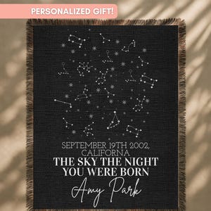 May include: Black woven throw blanket with white constellations and text. The text reads "SEPTEMBER 19TH 2002, CALIFORNIA, THE SKY THE NIGHT YOU WERE BORN, Amy Park." The blanket has a fringed edge and the words "PERSONALIZED GIFT!" at the top.