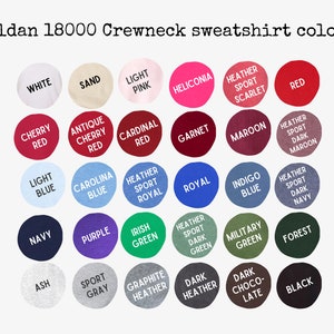 May include: A color chart for Gildan 18000 crewneck sweatshirts featuring thirty circular swatches labeled with color names including white, sand, light pink, heliconia, red, cherry red, cardinal red, garnet, maroon, royal, indigo, navy, purple, green, and black.