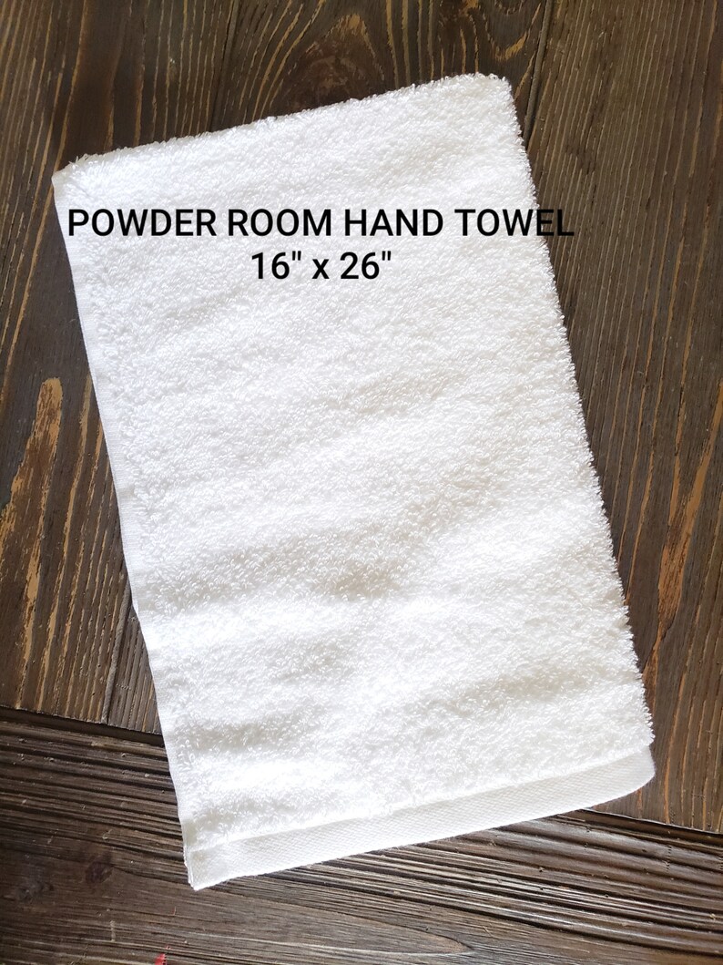 May include: White hand towel with the text "POWDER ROOM HAND TOWEL 16" x 26""