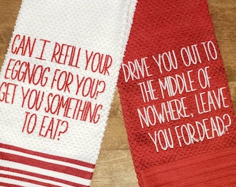 May include: Two kitchen towels, one white and one red. The white towel has red stripes and text that reads "CAN I REFILL YOUR EGGNOG FOR YOU? GET YOU SOMETHING TO EAT?" The red towel has white text that reads "DRIVE YOU OUT TO THE MIDDLE OF NOWHERE, LEAVE YOU FOR DEAD?"