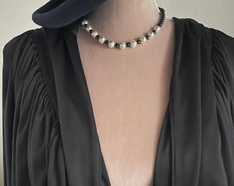 Necklace - black glass beads with silver lace look embellishments.