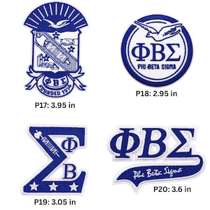 May include: Four blue and white embroidered patches. One patch features a crest with a bird and the text "Founded 1914". Another is a circle with "Phi Beta Sigma" and a bird. The other two patches have the Greek letters ΦΒΣ and the text "Phi Beta Sigma".