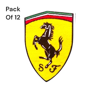 May include: Embroidered patch featuring the Ferrari logo, a black prancing horse on a yellow shield. The shield has a green, red, and white border. The text "Pack Of 12" is in the upper left corner. The letters "S" and "F" are at the bottom.