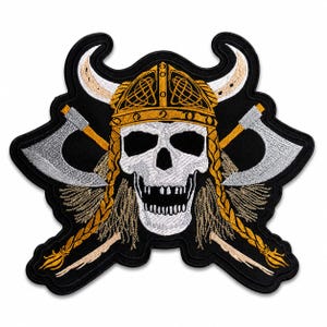 May include: Embroidered patch featuring a skull wearing a Viking helmet with crossed axes. The skull is white, the helmet is gold, and the axes are silver. The patch has a black background and gold braids.