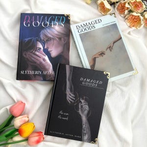 May include: Three hardcover books titled Damaged Goods with gold corner accents. One cover features two people, another shows reaching hands, and the third displays hands with a snake tattoo and the text Her scar. His mark. SLYTHERIN AFTER.