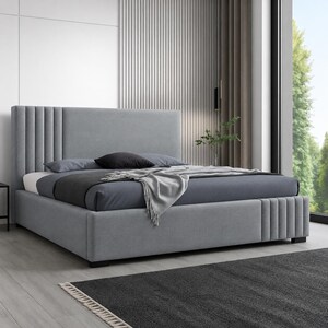 May include: A contemporary grey upholstered bed with a high headboard and a low base. The headboard has vertical panels on the sides. The bed is made with grey and black bedding and a grey throw.