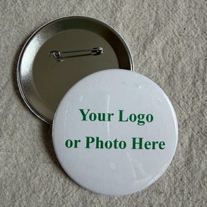 May include: A white ceramic mug with a black handle and the text "But First, Coffee" in a bold, black font. The mug is set against a neutral background, highlighting its simple design.