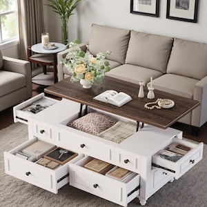 May include: A white rectangular coffee table with a dark wood grain lift-top surface. The table features multiple pull-out drawers on the sides and front, revealing interior storage compartments containing books, small boxes, and various personal items.