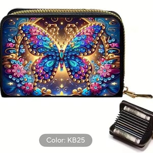 May include: Black zippered wallet featuring a vibrant butterfly design in shades of blue, purple, and gold. The butterfly is the focal point, surrounded by floral accents. The wallet is open, revealing card slots.