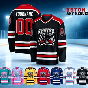 May include: A black hockey jersey featuring red and white stripes on the sleeves and hem, with a custom logo graphic on the chest and the text YOURNAME and 00 on the back. The design includes a V-neck collar and long sleeves with red shoulders.