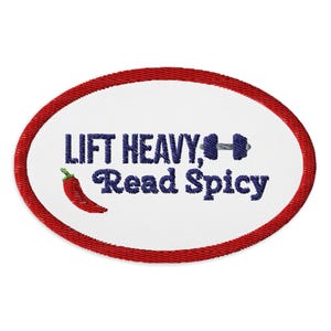 May include: Oval embroidered patch with a red border and white center. The patch features the text "LIFT HEAVY, Read Spicy" in dark blue, along with a dumbbell and a red chili pepper.