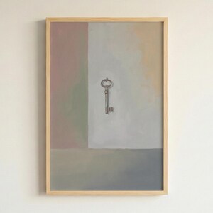 May include: A framed artwork featuring an antique key against a backdrop of muted pastel colors. The key is centered, with a detailed design. The artwork is encased in a light-colored wooden frame, creating a minimalist aesthetic.