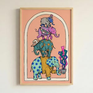 May include: A framed art print with a quirky illustration of elephants stacked on top of each other. The elephants are in shades of blue, pink, and green, wearing hats and jackets. The background is a light peach colour.