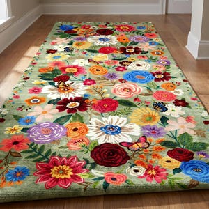 May include: A rectangular area rug featuring a sage green background densely covered in a vibrant, multicolored floral pattern. The design includes various blossoms in shades of red, pink, orange, yellow, blue, and purple, interspersed with small butterflies.