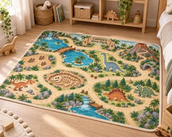 May include: A rectangular area rug featuring a colorful illustrated dinosaur park scene with winding paths, a blue lake, a waterfall, a volcano, and various dinosaurs. The text Lennox's Dino Park is printed on a wooden-style sign in the upper right.