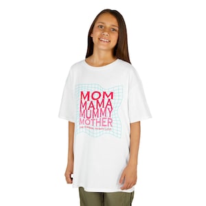 May include: White t-shirt with the words "MOM MAMA MUMMY MOTHER" in pink and red, with a blue grid design. The text "ONE PERSON INFINITE LOVE" is below the words. The shirt is worn by a person.