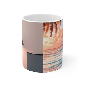 May include: White ceramic coffee mug featuring a split design. One side displays a sunset scene with a palm tree, ocean, and clouds. The other side shows a minimalist design with a dark gray rectangle and a light pink background.
