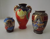 A Vintage Trio of Satsuma Vases, Mid-Century Art Pottery, Japanese Figures And Flowers, Raised Designs, Circa 1945-1952