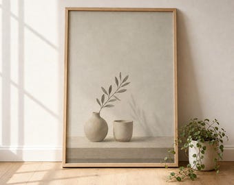 May include: A rectangular framed wall art print featuring a beige background with a light-colored ceramic vase containing a single leafy branch next to a small matching cup. The composition is set on a flat surface with soft shadows cast across the scene.