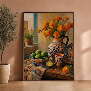 May include: A framed still life painting featuring a vibrant display of marigold flowers in a blue and white vase. A bowl of green limes, a patterned plate, and a small cup are arranged on a wooden table, with a colorful textile and a slice of lime.