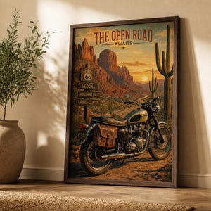 May include: A framed wall art print titled THE OPEN ROAD AWAITS, featuring a vintage motorcycle parked in a desert landscape with red rock formations, a tall saguaro cactus, and a wooden signpost pointing toward Route 66, Sedona, and Grand Canyon.