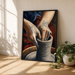 May include: A framed wall art print depicting a pair of hands covered in wet gray clay shaping a tall cylindrical vessel on a pottery wheel. The illustration features a dark blue and deep red background with visible brushstrokes and textures.