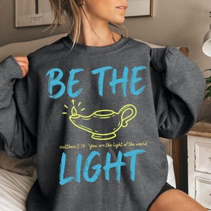 Be The Light Christian Sweatshirt, Matthew 5:14 Bible Verse Church Sweater, Trendy Faith Based Apparel For Men And Women, Religious Gift