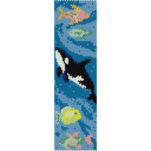May include: A beaded bookmark featuring an underwater scene. A black and white orca swims among colorful fish, including a pink and yellow fish, and a yellow fish. The background is a blue ocean with swirling patterns.