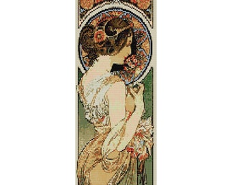 May include: A vintage art nouveau style poster featuring a woman in a flowing white dress with a floral design. The woman is surrounded by a decorative frame with floral motifs and a circular design.