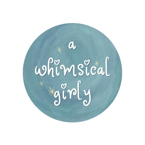 May include: A circular sticker with a textured, dusty blue background featuring the white hand-lettered text 'a whimsical girly' centered in the middle. Small, pale yellow star-shaped accents are scattered around the white lettering.