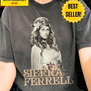 May include: A charcoal gray mineral-washed t-shirt featuring a vintage-style black and white photographic print of a person with long wavy hair and a flower accessory. Below the image, the text SIERRA FERRELL is printed in a bold, serif font.
