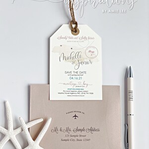 May include: A save the date card with a tropical theme. The card is shaped like a luggage tag and features a watercolor background with palm trees and a plane. The text on the card reads "Sandy toes and Salty kisses" and "Michelle & Junior". The date of the wedding is 04.16.21 and the location is "Montego Bay, Jamaica". The card also includes the name of the hotel, Hyatt Ziva Rose Hall, and contact information for travel inquiries.