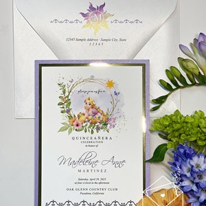 May include: Purple and gold Quinceañera invitation with a watercolor illustration of a princess with blonde hair and a yellow dress. The text reads "Please join us for a Quinceañera Celebration in honor of Madeleine Anne Martinez. Saturday, April 29, 2023 at four o'clock in the afternoon. Oak Glenn Country Club, Pasadena, California."