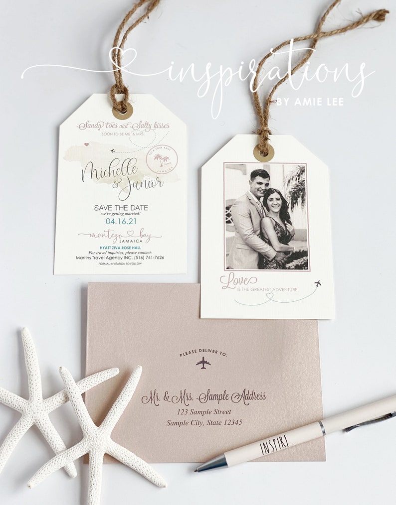 May include: A wedding invitation in the shape of a luggage tag with a photo of the couple, the text "Sandy toes and Salty kisses", "Michelle & Junior", "Save the Date", "04.16.21", "Montego Bay", "Jamaica", "Love is the greatest adventure!" and the address "Mr. & Mrs. Sample Address, 123 Sample Street, Sample City, State 12345".