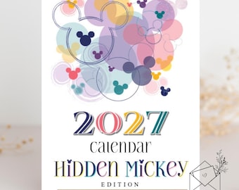 May include: A 2027 calendar featuring a Hidden Mickey edition title. The design displays overlapping translucent circles in pastel shades of pink, purple, blue, and yellow, accented with dark blue Mickey Mouse head silhouettes.