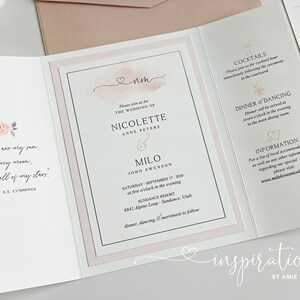 May include: Wedding invitation with a soft pink and white design. The invitation includes the names Nicolette and Milo, the wedding date, and location. The text "You are my sun, my moon, and all of my stars" is also included.